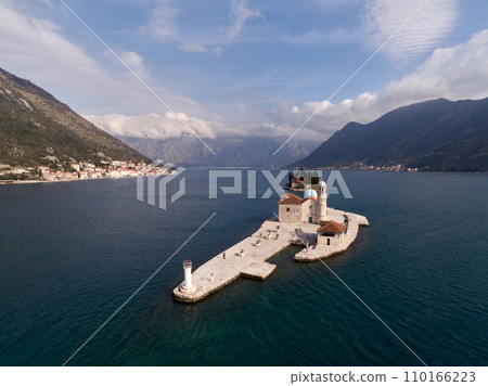 Church of Our Lady on the Rocks on the island of Gospa od Skrpjela with a lighthouse. Montenegro. Drone Church of Our Lady on the Rocks on the island of Gospa od Skrpjela with a lighthouse. Montenegro. Drone 110166223