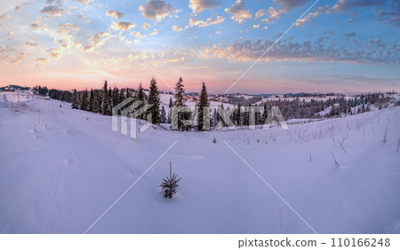 Small and quiet alpine village and winter sunrise snowy mountains around, Voronenko, Carpathian, Ukraine. 110166248