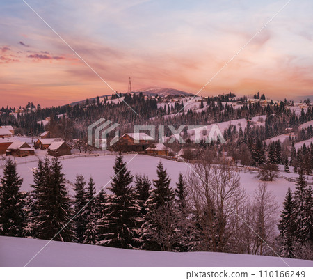 Small and quiet alpine village and winter sunrise snowy mountains around, Voronenko, Carpathian, Ukraine. 110166249