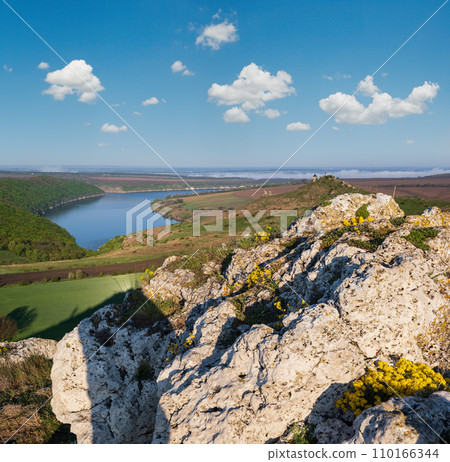 Ukraine without russian aggression. Amazing spring view on the Dnister River Canyon with picturesque rocks, fields, flowers. This place named Shyshkovi Gorby, Nahoriany, Chernivtsi region, Ukraine. Ukraine without russian aggression. Amazing spring view on the Dnister River Canyon with picturesque rocks, fields, flowers. This place named Shyshkovi Gorby, Nahoriany, Chernivtsi region, Ukraine. 110166344