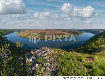 Amazing spring view on the Dnister River Canyon with picturesque rocks, fields, flowers. This place named Shyshkovi Gorby, Nahoriany, Chernivtsi region, Ukraine. Amazing spring view on the Dnister River Canyon with picturesque rocks, fields, flowers. This place named Shyshkovi Gorby, Nahoriany, Chernivtsi region, Ukraine. 110166347