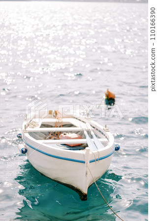 White fishing boat moored in the sea White fishing boat moored in the sea 110166390