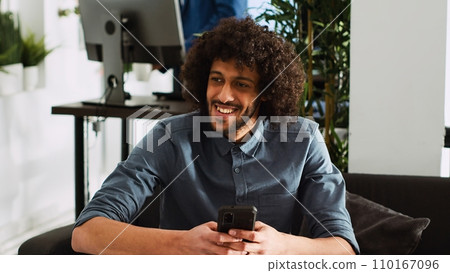 Employee examining project data and working on smartphone at desk in business office, entrepreneurship. Professional analyst reviews report at coworking space, unicorn business. Handheld shot. 110167096