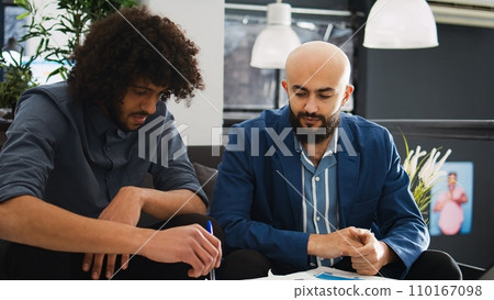 Angry boss throwing documents at office employee, furious aggressive manager expressing disappointment at company job. Businessman feeling frustrated with analyst, screaming in open space. 110167098