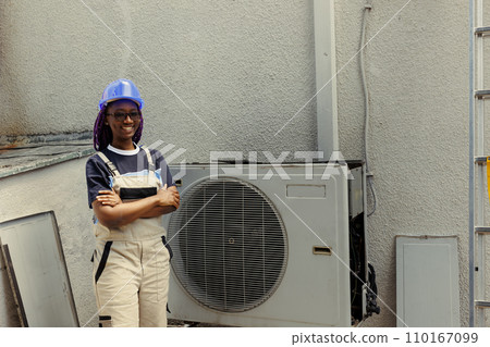 Portrait of cheerful knowledgeable professional proud of work done, standing in front of fixed hvac system. Specialist contracted by client happy with smooth servicing of internal condenser parts Portrait of cheerful knowledgeable professional proud of work done, standing in front of fixed hvac system. Specialist contracted by client happy with smooth servicing of internal condenser parts 110167099