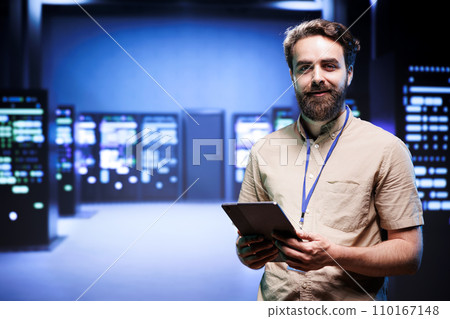 Portrait of technician making sure servers in cloud computing business service are correctly equipped, to provide redundancy and automatic failover of clusters to minimize failure of hardware Portrait of technician making sure servers in cloud computing business service are correctly equipped, to provide redundancy and automatic failover of clusters to minimize failure of hardware 110167148