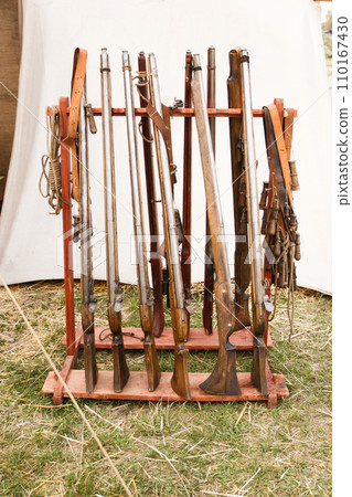 Old vintage muskets standing in the rack. 110167430