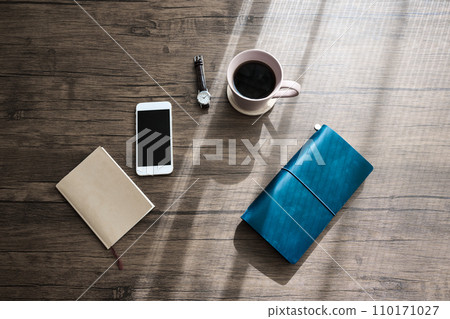 Smartphone and notebook placed on the desk 110171027