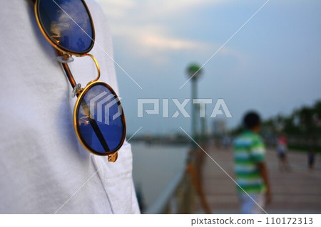Sunglasses that look great with a white T-shirt at a resort Sunglasses that look great with a white T-shirt at a resort 110172313