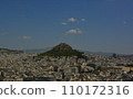 Greek cityscape: mountains appearing among houses 110172316