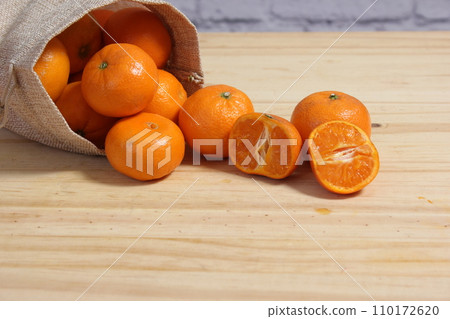 Bag of Fresh Oranges on Wooden Table 110172620