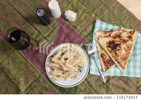 Plate of Pasta Carbonara With Italian Flat Bread on Rustic Table Plate of Pasta Carbonara With Italian Flat Bread on Rustic Table 110172633