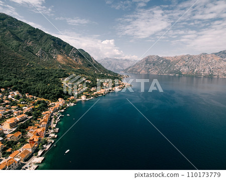 Red roofs of houses with private piers on the shores of the Bay of Kotor. Dobrota, Montenegro. Drone Red roofs of houses with private piers on the shores of the Bay of Kotor. Dobrota, Montenegro. Drone 110173779