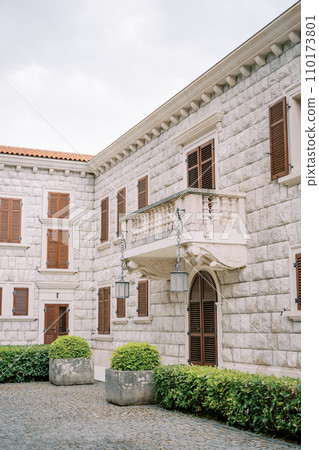Balcony with hanging lanterns above the arched door of Villa Milocer. Montenegro 110173801