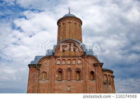 The Friday Church in Chernihiv, a historic brick tower, stands in stark contrast against a backdrop of a serene blue sky with drifting clouds. The Friday Church in Chernihiv, a historic brick tower, stands in stark contrast against a backdrop of a serene blue sky with drifting clouds. 110174508