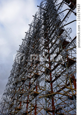 A complex structure of rusted metal and wires against a cloudy sky. Duga is a Soviet over-the-horizon radar station for an early detection system for ICBM launches. 110174587