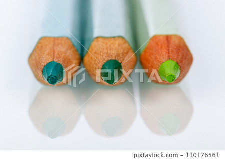 green pencil on white background 110176561