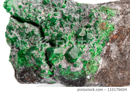 macro stone mineral uvarovite on a white background 110176604