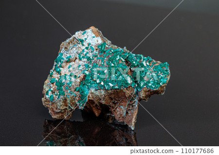 macro mineral stone Dioptase on a gray background macro mineral stone Dioptase on a gray background 110177686