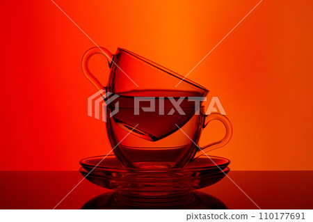 beautiful two cups with tea on orange and red background beautiful two cups with tea on orange and red background 110177691