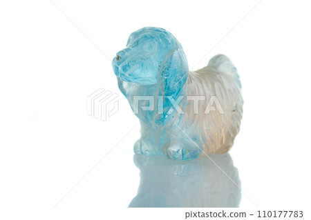 beautiful statuette of a dog from the mineral topaz on a white background beautiful statuette of a dog from the mineral topaz on a white background 110177783