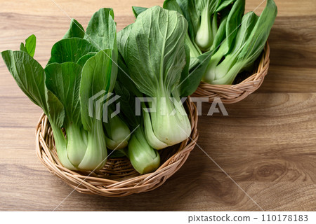 Bok choy or Pak choi (Chinese cabbage) in basket on wooden table, Organic vegetables Bok choy or Pak choi (Chinese cabbage) in basket on wooden table, Organic vegetables 110178183