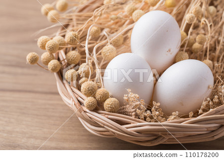 Organic white leghorn egg from free range farm in basket on wooden table 110178200