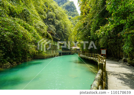 Lush green plants and turquoise river water. A great place to travel in summer. 110178639