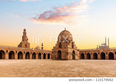 Minaret and ablution fountain of the Ibn Tulun Mosque, sunset view of a famous place of Cairo, Egypt Minaret and ablution fountain of the Ibn Tulun Mosque, sunset view of a famous place of Cairo, Egypt 110179082