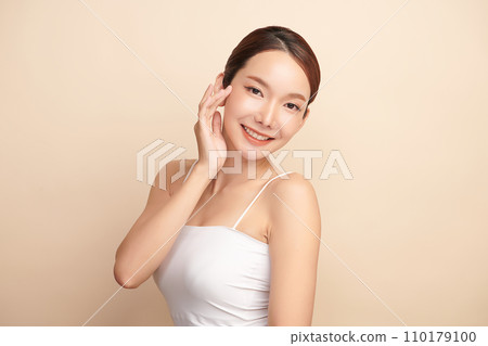 Beautiful young asian woman with clean fresh skin on beige background, Face care, Facial treatment, Cosmetology, beauty and spa, Asian women portrait. 110179100