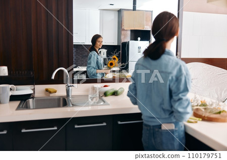 Happy Caucasian Woman Cleaning the Kitchen Sink, Enjoying Healthy Food Preparation Indoors Happy Caucasian Woman Cleaning the Kitchen Sink, Enjoying Healthy Food Preparation Indoors 110179751