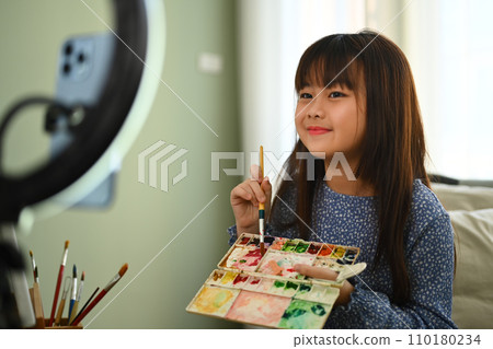 Asian little girl painting picture and recording video to share on social media. Asian little girl painting picture and recording video to share on social media. 110180234