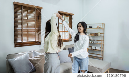 Young lesbian romantic couple in love dancing spending time together at home 110180796