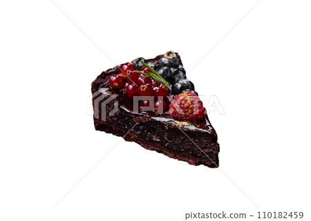 Delicious sweet chocolate brownie cake with blueberries, currants and raspberries 110182459