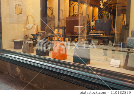 Fashion leather handbags in a boutique shop display window in Florence, Italy Fashion leather handbags in a boutique shop display window in Florence, Italy 110182859