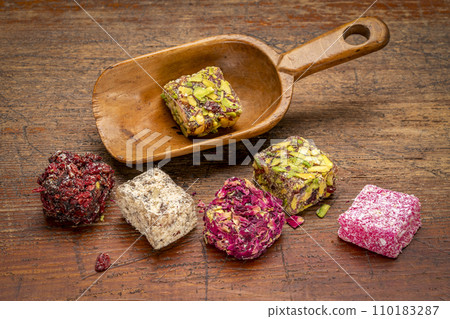 traditional Turkish delight (lokum) - soft, juicy, and chewy dessert from the middle east in a vintage wooden scoop traditional Turkish delight (lokum) - soft, juicy, and chewy dessert from the middle east in a vintage wooden scoop 110183287