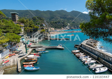 Italy, Monterosso,Italy, Monterosso, beach and parasols in front of the giant, statue of the giant god Poseidon or Neptune Italy, Monterosso,Italy, Monterosso, beach and parasols in front of the giant, statue of the giant god Poseidon or Neptune 110183447