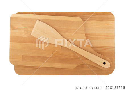 Top view of a kitchen set of wooden cutting boards and a kitchen spatula. Top view of a kitchen set of wooden cutting boards and a kitchen spatula. 110183516