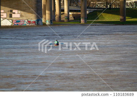 A man kayaks on the Rhine river in Dusseldorf A man kayaks on the Rhine river in Dusseldorf 110183689