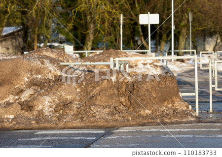 Shoveled pile of muddy snow during winter, road cleaning 110183733