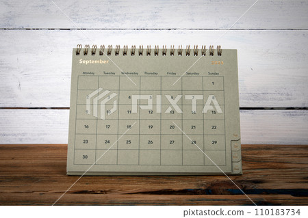 SEPTEMBER 2024 cardboard desk calendar and planner on a wooden texture table SEPTEMBER 2024 cardboard desk calendar and planner on a wooden texture table 110183734