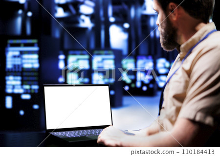 Expert using mock up laptop to evaluate supercomputers with high computing power enabling server room to support demanding applications, including virtual reality and video rendering workloads Expert using mock up laptop to evaluate supercomputers with high computing power enabling server room to support demanding applications, including virtual reality and video rendering workloads 110184413