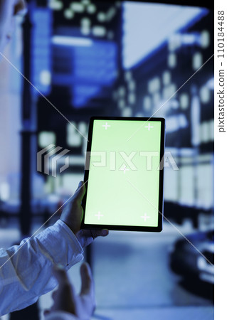 Person having fun walking around city at night, scrolling on social media using mockup tablet, close up. Citizen using green screen device while strolling in empty metropolitan setting Person having fun walking around city at night, scrolling on social media using mockup tablet, close up. Citizen using green screen device while strolling in empty metropolitan setting 110184488