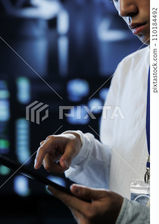 Precise programmer between data center machines providing processing resources for companies worldwide. Proficient developer fixes high tech workspace supercomputers used for storing large databases Precise programmer between data center machines providing processing resources for companies worldwide. Proficient developer fixes high tech workspace supercomputers used for storing large databases 110184492