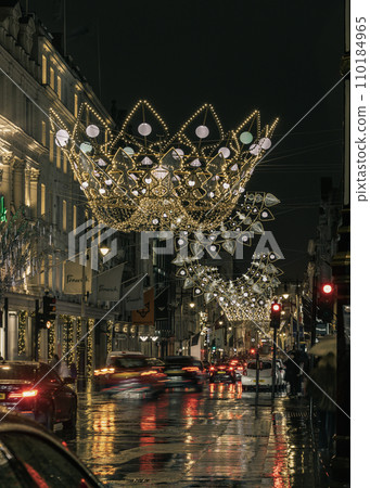 Christmas crowns decoration led lights display. Dramatic view of the traditional Christmas decoration lights hanging above Bond street during dusk. Christmas crowns decoration led lights display. Dramatic view of the traditional Christmas decoration lights hanging above Bond street during dusk. 110184965