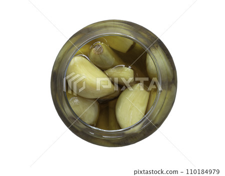 Garlic pickled in Apple cider vinegar with Rock sugar in clear glass isolated on white background with clipping path. Garlic pickled in Apple cider vinegar with Rock sugar in clear glass isolated on white background with clipping path. 110184979