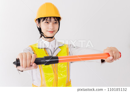 A security guard wearing a reflective vest to guide A security guard wearing a reflective vest to guide 110185132
