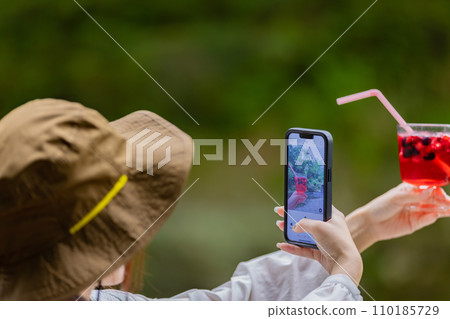 Young woman having a nice drink outdoors 110185729