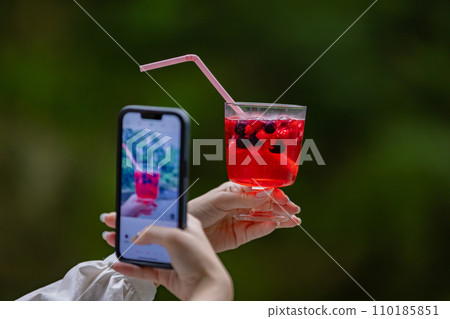 Young woman having a nice drink outdoors 110185851