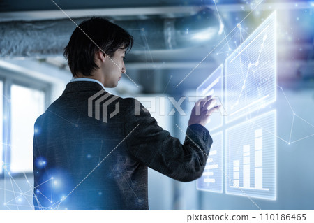 Businessman manipulating a hologram Businessman manipulating a hologram 110186465